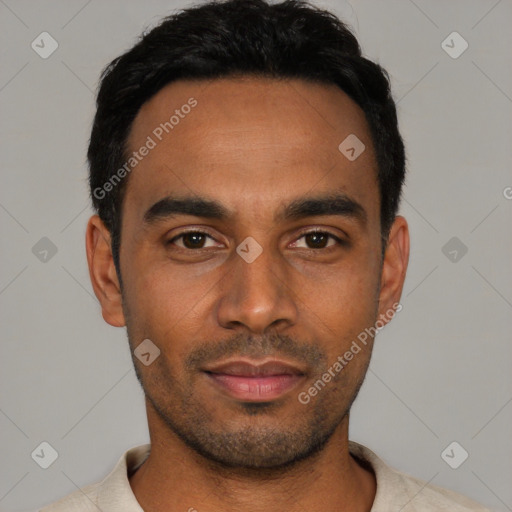 Joyful latino young-adult male with short  black hair and brown eyes