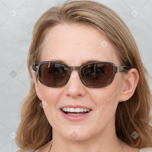 Joyful white young-adult female with medium  brown hair and blue eyes