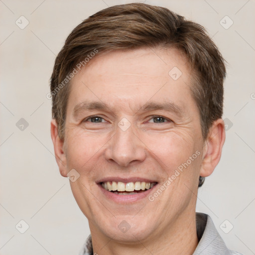 Joyful white adult male with short  brown hair and grey eyes