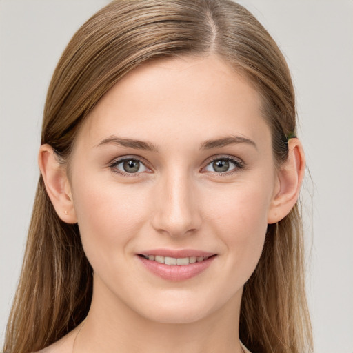 Joyful white young-adult female with long  brown hair and blue eyes