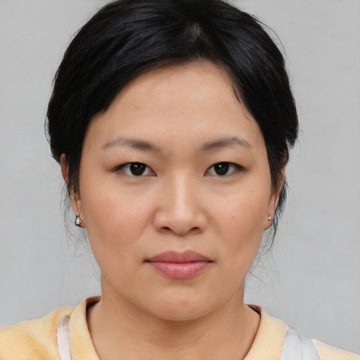 Joyful asian young-adult female with medium  brown hair and brown eyes