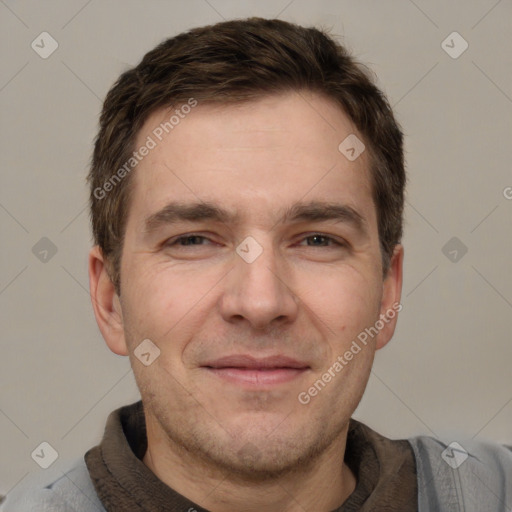 Joyful white adult male with short  brown hair and grey eyes