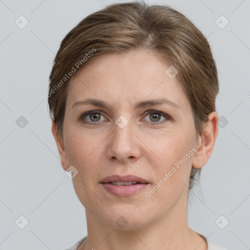 Joyful white adult female with short  brown hair and grey eyes