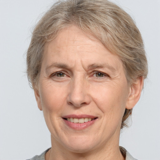 Joyful white middle-aged female with medium  brown hair and grey eyes