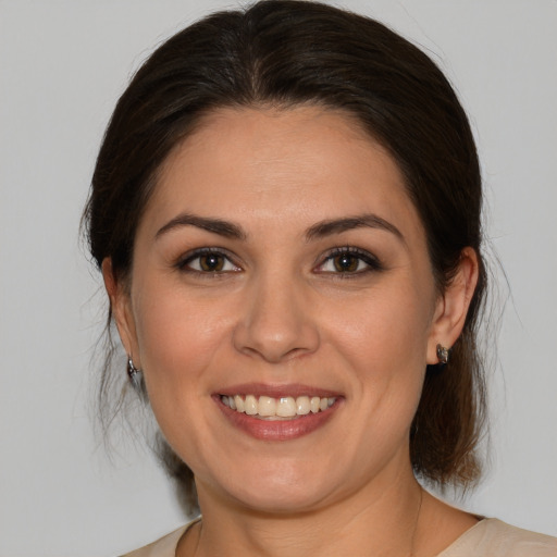 Joyful white young-adult female with medium  brown hair and brown eyes