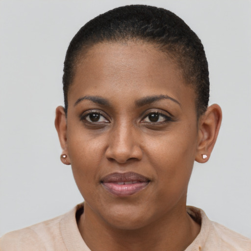 Joyful black young-adult female with short  black hair and brown eyes