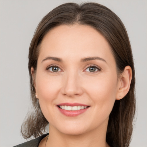 Joyful white young-adult female with medium  brown hair and grey eyes