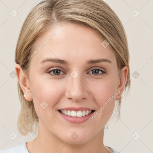 Joyful white young-adult female with medium  brown hair and blue eyes