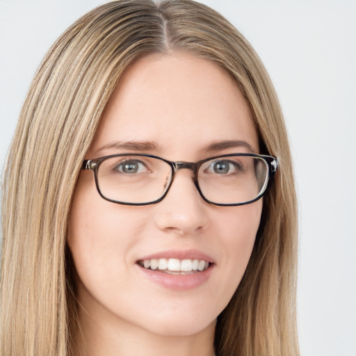 Joyful white young-adult female with long  brown hair and green eyes