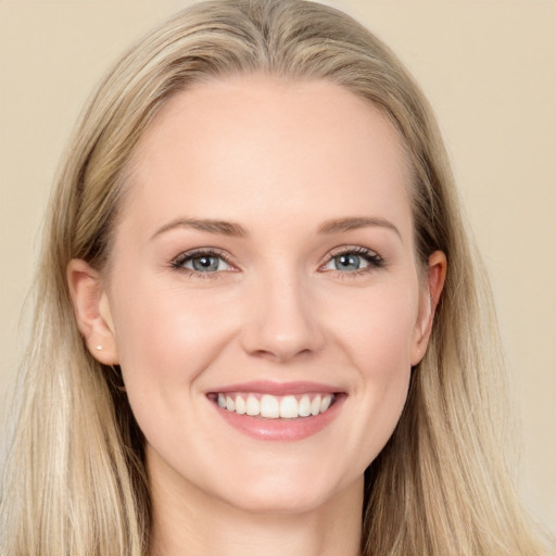 Joyful white young-adult female with long  brown hair and blue eyes