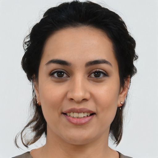Joyful latino young-adult female with medium  brown hair and brown eyes
