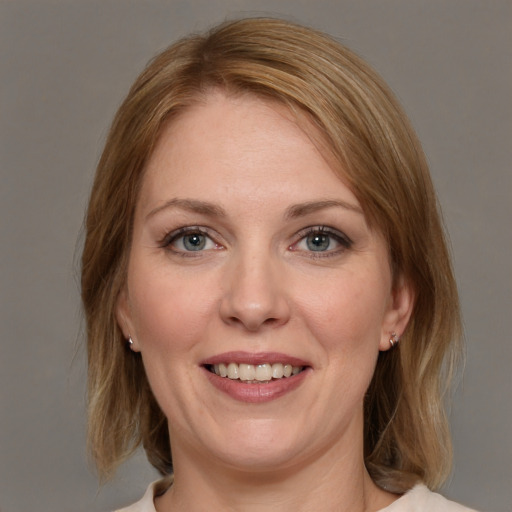 Joyful white young-adult female with medium  brown hair and blue eyes