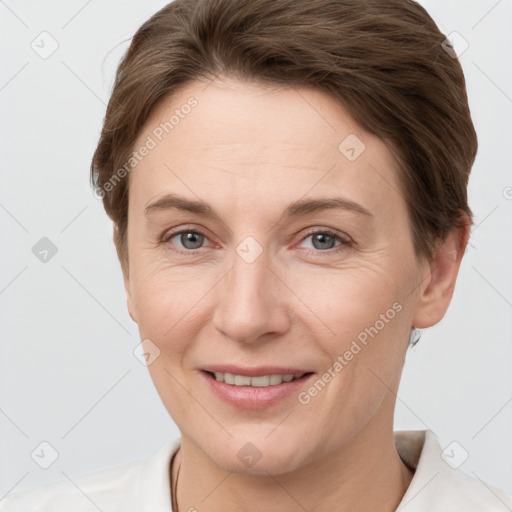 Joyful white adult female with short  brown hair and grey eyes