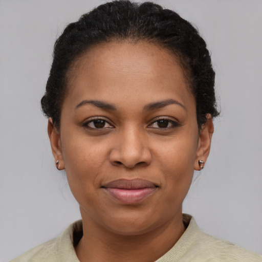 Joyful black young-adult female with short  brown hair and brown eyes