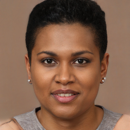 Joyful black young-adult female with short  brown hair and brown eyes