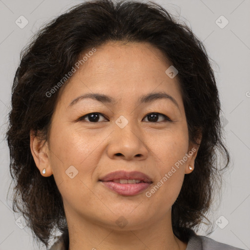 Joyful white adult female with medium  brown hair and brown eyes