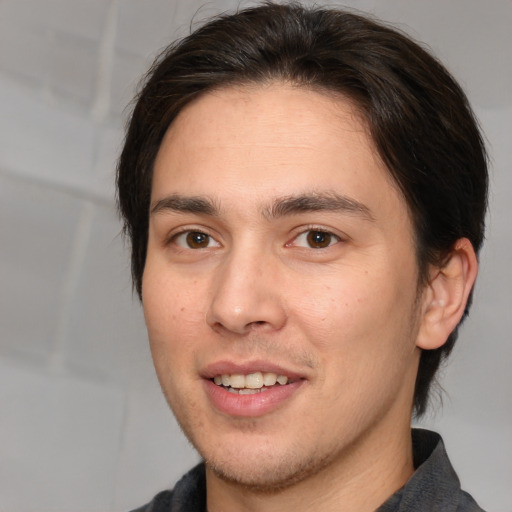 Joyful white young-adult male with medium  brown hair and brown eyes