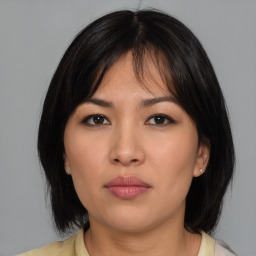 Neutral asian young-adult female with medium  brown hair and brown eyes