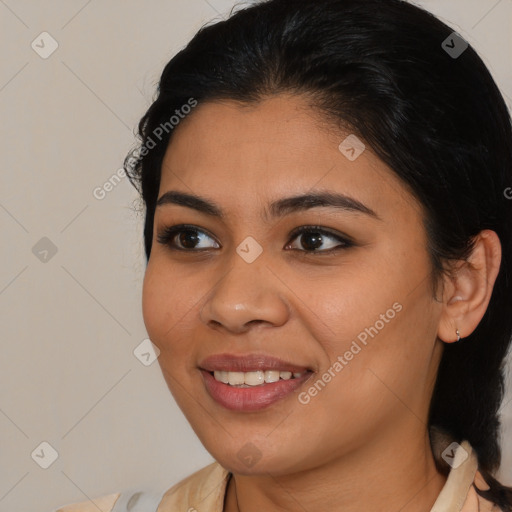 Joyful latino young-adult female with medium  brown hair and brown eyes