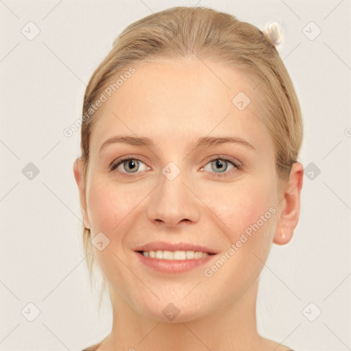 Joyful white young-adult female with short  brown hair and blue eyes