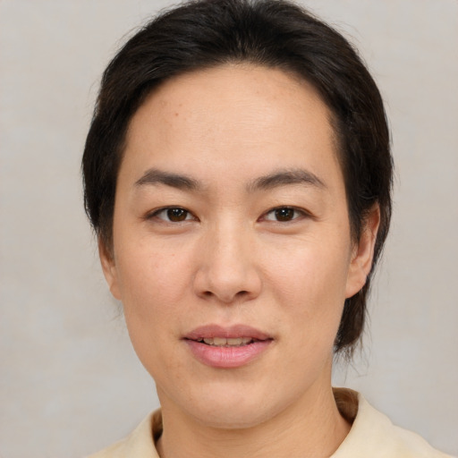 Joyful asian young-adult female with medium  brown hair and brown eyes