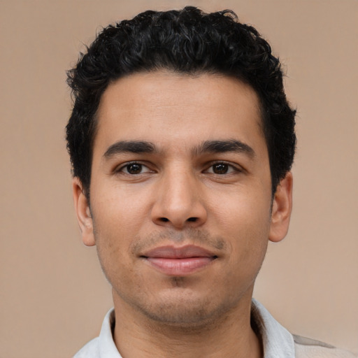 Joyful latino young-adult male with short  black hair and brown eyes