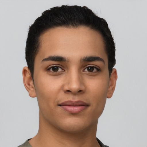 Joyful latino young-adult male with short  brown hair and brown eyes