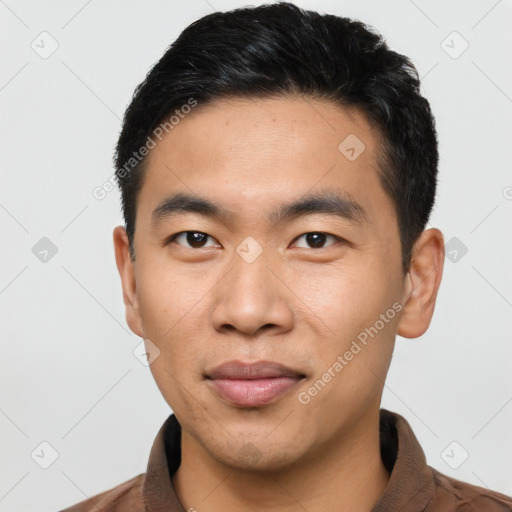 Joyful asian young-adult male with short  black hair and brown eyes