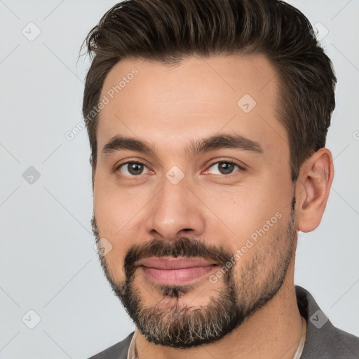 Joyful white young-adult male with short  brown hair and brown eyes