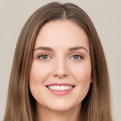 Joyful white young-adult female with long  brown hair and green eyes