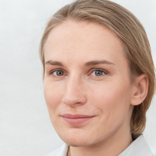 Joyful white young-adult female with medium  brown hair and blue eyes