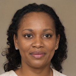 Joyful black adult female with medium  brown hair and brown eyes