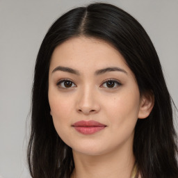 Joyful asian young-adult female with long  brown hair and brown eyes