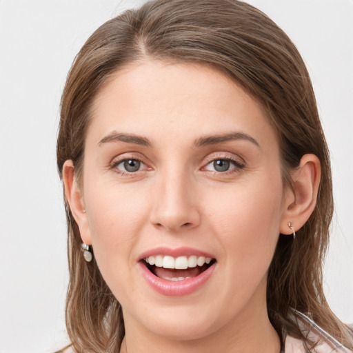 Joyful white young-adult female with medium  brown hair and grey eyes