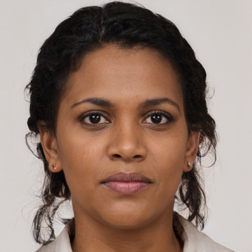 Joyful black young-adult female with medium  brown hair and brown eyes