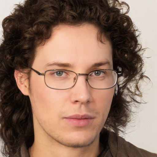 Neutral white young-adult male with medium  brown hair and green eyes