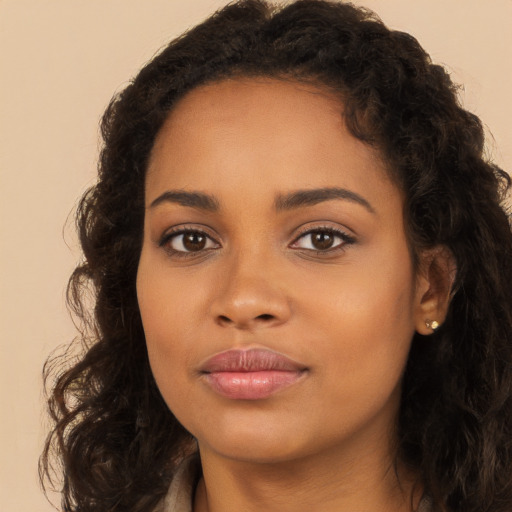 Joyful latino young-adult female with long  brown hair and brown eyes