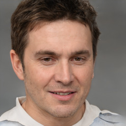 Joyful white adult male with short  brown hair and brown eyes