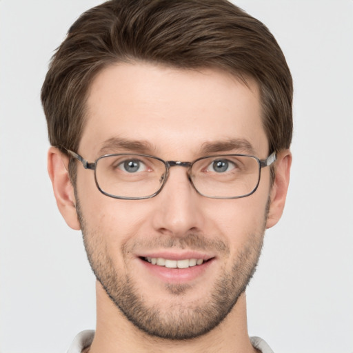 Joyful white young-adult male with short  brown hair and grey eyes