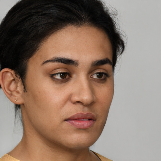 Neutral latino young-adult female with short  brown hair and brown eyes