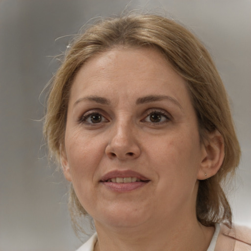 Joyful white adult female with medium  brown hair and brown eyes