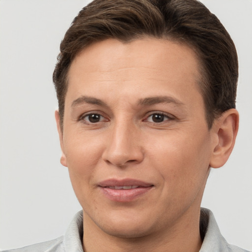 Joyful white adult female with short  brown hair and brown eyes