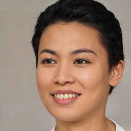 Joyful asian young-adult female with short  brown hair and brown eyes