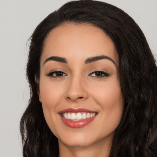 Joyful white young-adult female with long  black hair and brown eyes