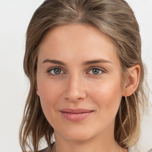 Joyful white young-adult female with medium  brown hair and grey eyes