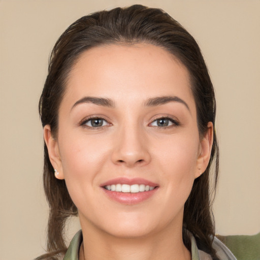 Joyful white young-adult female with long  brown hair and brown eyes