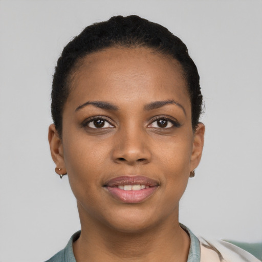 Joyful black young-adult female with short  black hair and brown eyes