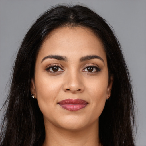 Joyful latino young-adult female with long  brown hair and brown eyes