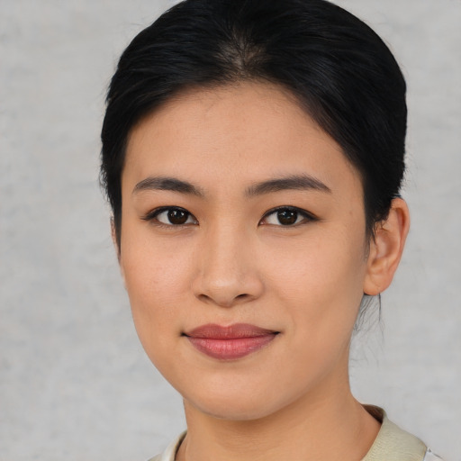 Joyful asian young-adult female with short  brown hair and brown eyes