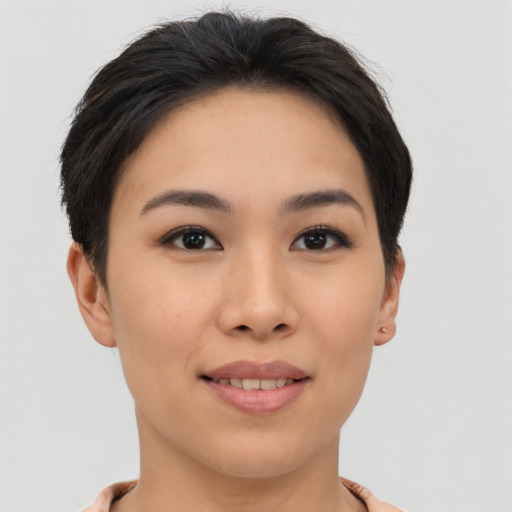 Joyful asian young-adult female with short  brown hair and brown eyes